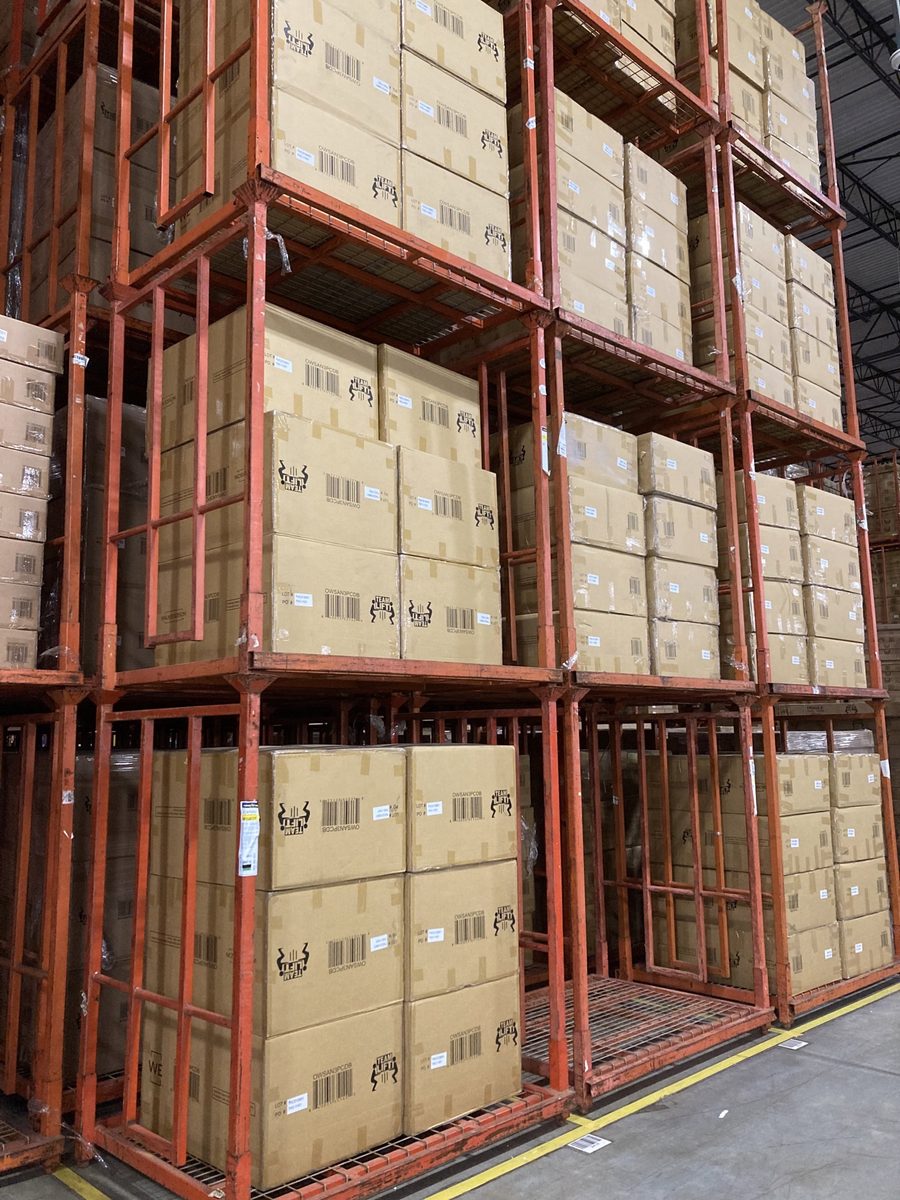 Orange stack racks loaded with inventory in warehouse