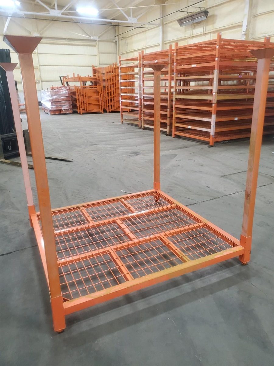Single orange stack rack with wire mesh deck in warehouse