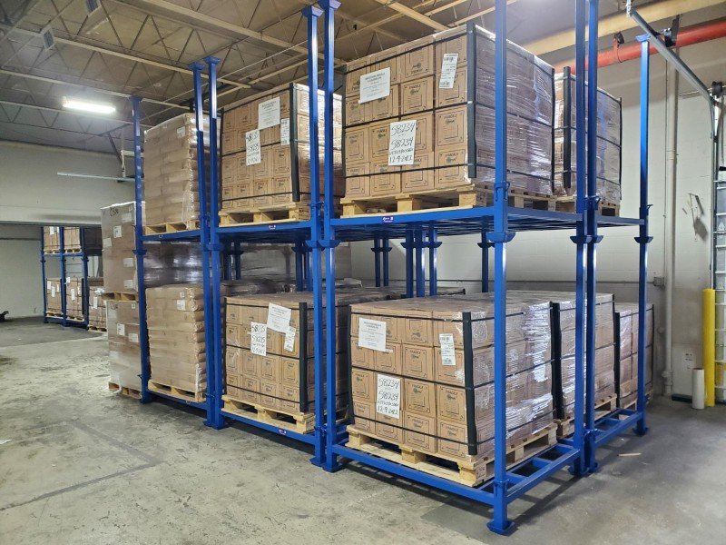 Used blue stack racks loaded with inventory